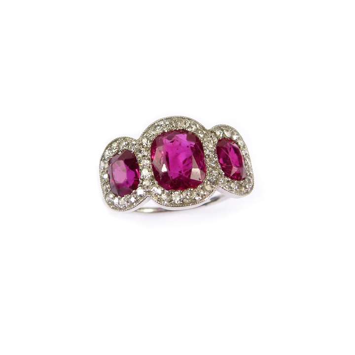 Early 20th century ruby and diamond three stone cluster ring